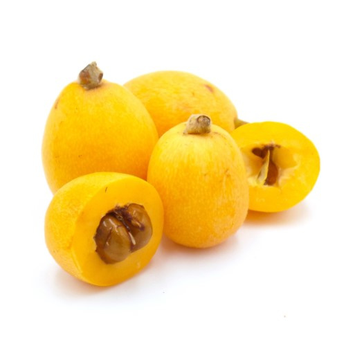 KI generiert: Mehrere gelbe, ovale Früchte, einige sind aufgeschnitten, um die Kerne zu zeigen.